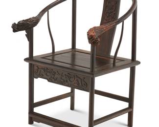 2313
A Chinese carved hardwood horseshoe chair
20th century
The rounded crest rail terminating in dragon's head armrests above a splat and front apron each carved with dragon figures
37" H x 29.5" W x 25.5" D
Estimate: $300 - $500