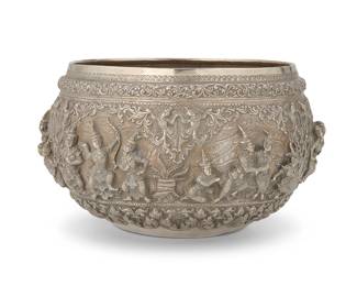 2280
A Burmese sterling silver bowl
20th century
Unmarked
The round vessel with elaborate chased and repoussé scrolled motifs surrounding a band of haute-relief figures
7" H x 12" Dia.
43.3 oz. troy approximately
Estimate: $1,000 - $1,500