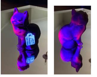 This is a rare Mosser UV glow cat. We are holding a blacklight above it in this picture.