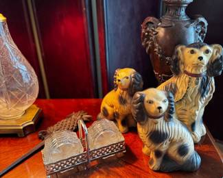 replica staffordshire dog figurines and glass coasters in a caddy