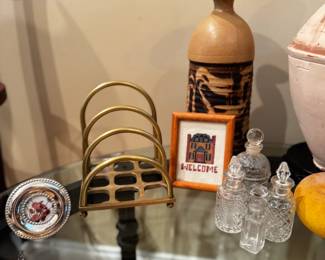 brass mail sorter, small glass bottles, various small cross stitch art, various clay and ceramic vases