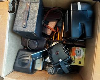 box of old cameras and camera accessories (flashes/camera bags/etc)