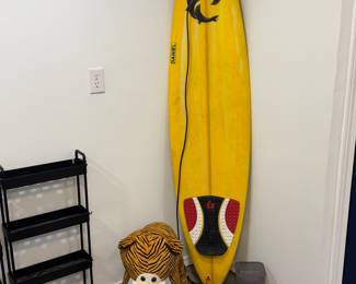 surf board and over sized stuffed animal