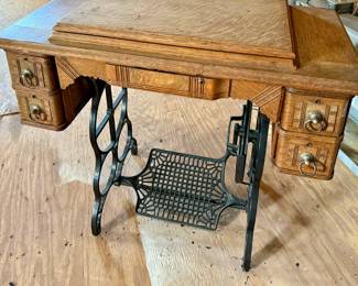 Antique Continental treadle sewing machine in tiger oak cabinet