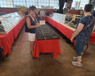 Tables on the left are full of Gold jewelry. Center Tables are $15 Sterling jewelry. Tables on the right are Sterling jewelry. Thousands of pieces of jewelry to browse through.