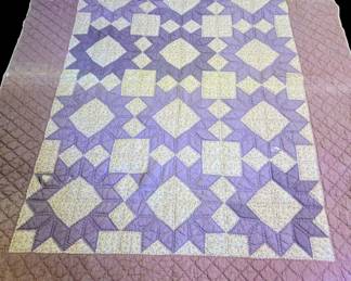 Antique Floral.Lavender/ purple/ cream color quilt hand stitched features a geometric pattern, possibly a variation of the Churn Dash /Pinwheel block