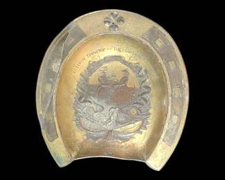 1904 bronze and brass historic souvenir ashtray the Louisiana Purchase shape of a horseshoe does have a repair on one side. I've never seen one like this! It's a surprise around here at every corner! 
