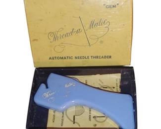 One of many vintage sewing items this is the automatic needle threader