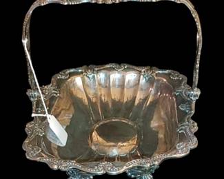Antique silver-plated swing-handle basket, likely dating from the Victorian or early 20th-century Art Nouveau period. 
Such baskets were commonly used for serving items like cake, fruit, or bread, and were popular for their decorative appeal as centerpieces during formal gatherings. 
I would definitely use this for a bread basket! 