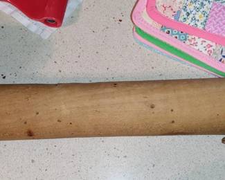 Antique French Rolling pin 
Unlike traditional American rolling pins, which have a center cylinder that rolls between two handles, French rolling pins consist of a wood hand turned thick dowel with "mushroom caps" on the ends. A French rolling pin is longer, giving you greater leverage when rolling out dough for pastries/cookies.
