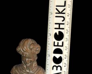Measuring around three and a half inches tall very heavy solid bronze