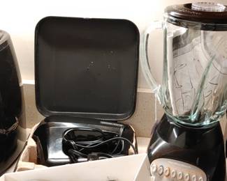 A kitchen full of small appliances air fryer waffle maker blender and more