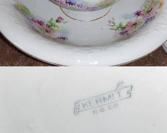KERMIT N.G. Co. refers to an early American porcelain company that operated from approximately 1870 to 1928, known for producing vintage ironstone and porcelain pieces like pitchers, chamber pots, and wash bowls. 