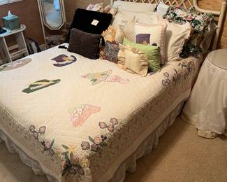Full-size bed with bamboo/rattan headboard; vintage hand-stitched folk-art ladies’ hats appliqué.