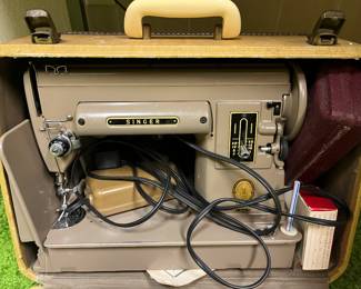 Singer 301A sewing machine with case and accessories.