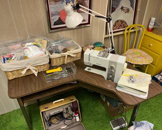Full sewing room with multiple machines, accessories, yarn, and more.