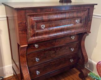 Empire style 1830’s chest of drawers.   In good condition for age.   Adorned with spectacular large glass knobs.  