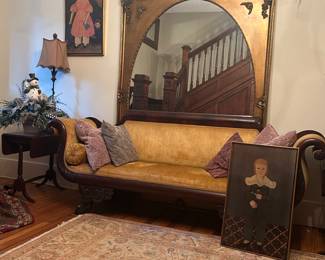 Vintage couch, grand mirror, side tables, lamps, wall decor, and hand knotted rug round out this sophisticated ensemble. 