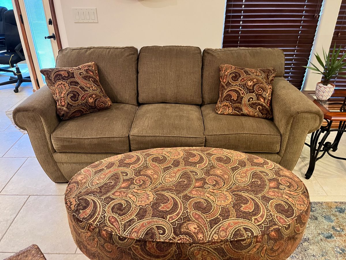 Beige sofa with matching pillows
oval ottoman