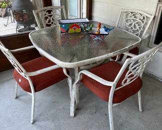 Glass top patio table with four chairs