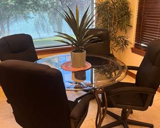 Round glass, top dining table with four chairs