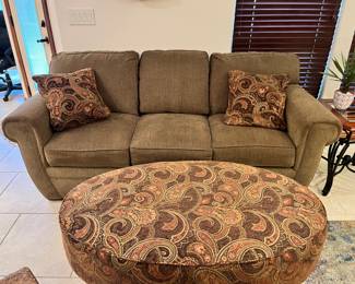 Beige sofa with matching pillows
oval ottoman