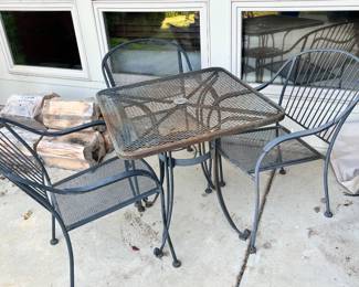 Wrought iron table with two chairs, one additional chair available