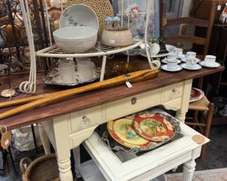 white end table with glass insert, plates, tea cups and saucers. 