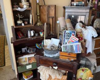 solid wood end table, basket, texas license plate, candlesticks, book shelf