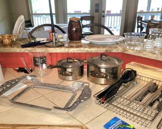 View of the kitchen includes French cookware, serving pieces, and more