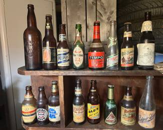 Various vintage amber beer bottles. The top left is a Weber’s embossed amber beer bottle.