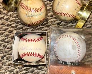 Autograph baseballs: upper left - Red Red Schoendienst, upper right - Hank Aaron, lower left Bob Uecker & lower right is the 1979 Brewers team signed baseball.