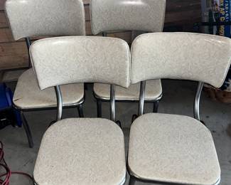 Vintage chrome vinyl kitchen dinette chairs. The seats and back are in great shape, except for the chair on the back left. Enlarge the pic and you can see the rip. These chairs would go GREAT with the yellow kitchen table.