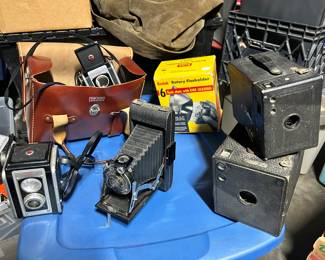 THIS is just a fraction of the various cameras and equipment. Review the listed items in the ‘Sales Description’ for more. Above includes a Kodak Duaflex II, Kodak #1, Brownie Boxes, Kodak Rotary Flashholder and remember thete are alot more related items not pictured. 