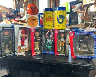 A selection of various sports bobble heads, Chicago Bulls radio and a couple of 'signed' Milwaukee Brewers Maxwell Coffee mugs.