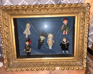 Framed in a vintage display box are a few Kewpies and their friends.