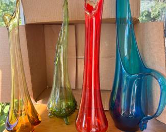 Sample of the many colored art glass.     From left to right: vintage Viking amber stretch swung MCM art glass vase, Viking green hobnail 3 toe swung vase,  Viking ruby red stretch vace, and a 1950s Viking blue glass picture with long lip.
