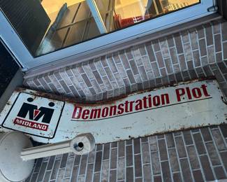 Two sided Midland Metal sign. Sign is not bent. It’s just the way it is leaning against the wall.