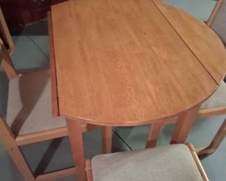 Great condition. Small Drop leaf table with four chairs. Very nice space saver