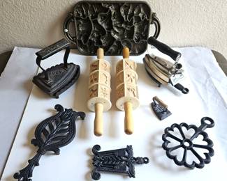 Lot of Vintage Charming Cast Iron Trivets, Irons, and Cookie Molds Plus Dutch Rolling Pins For Shortbread Cookies