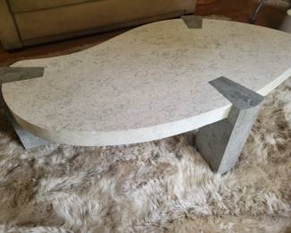marble top coffee table on an Australian sheep skin rug