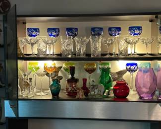 Colorful glasses and decor in back-lit cabinets