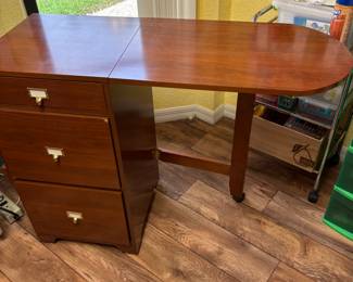 We have 2 of these cabinets that have a fold up extension arm that was used in sewing room. They are exactly the same and measure: closed 21” X 17”. Open 44” X 17”. 