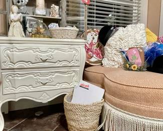 white nightstand, peach ottoman, boho waste basket, pillows, hats, hatbox 