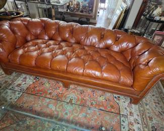 Tufted leather sofa with reversible cushion