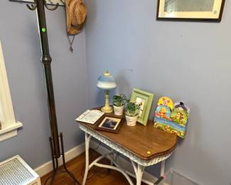 Painted wicker table $100, coat rack $50, decorative items $1, tub of silk florals $10, framed art $5, wall hat rack $10