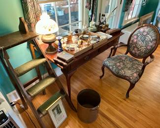Upholstered armchair $25, library ladder, Cherry writing table $50, oil lamp $25