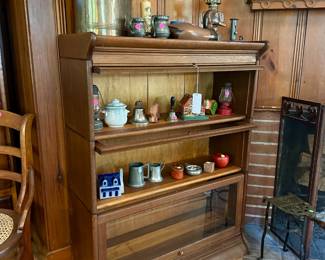 Stacking bookcase $450, tin watering can $50, wood duck $10, shelf clock $25, misc pewter, oil lamp, lanterns, figures and handbells most $5-10