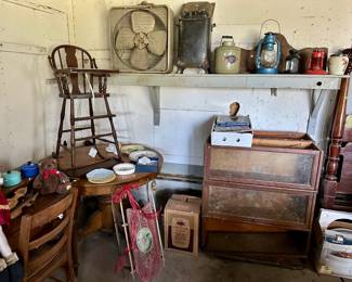 Garage items, including, a vintage high chair, portion of a stacking bookcase, vintage sled and lanterns, fan, etc