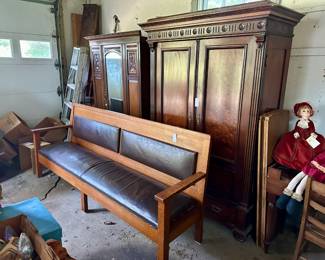 Garage items, including armoires, an upholstered bench, vintage dolls, etc